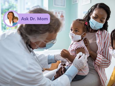 Doctor giving a little girl a shot.