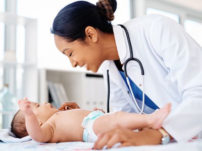 Pediatrician examining infant