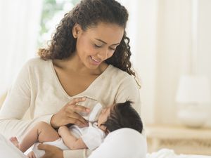 母亲用奶瓶喂婴儿