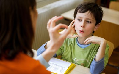 Boy working with a speech therapist