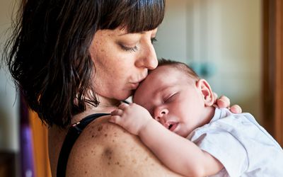 Mom kissing baby