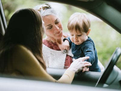 A picture of a mother leaving her child with his grandmother