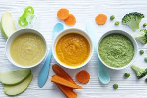An assortment of organic baby foods on a painted wood surface