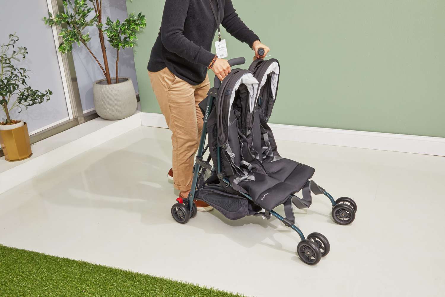 Uppababy G-Link 2 Double Stroller being folded by a woman