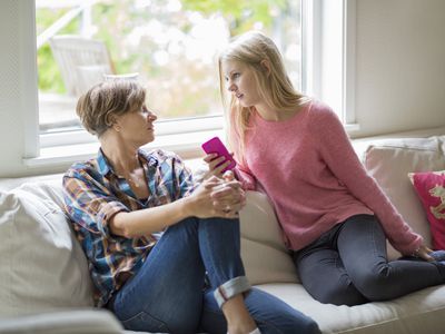 Mother and daughter conversing in living room