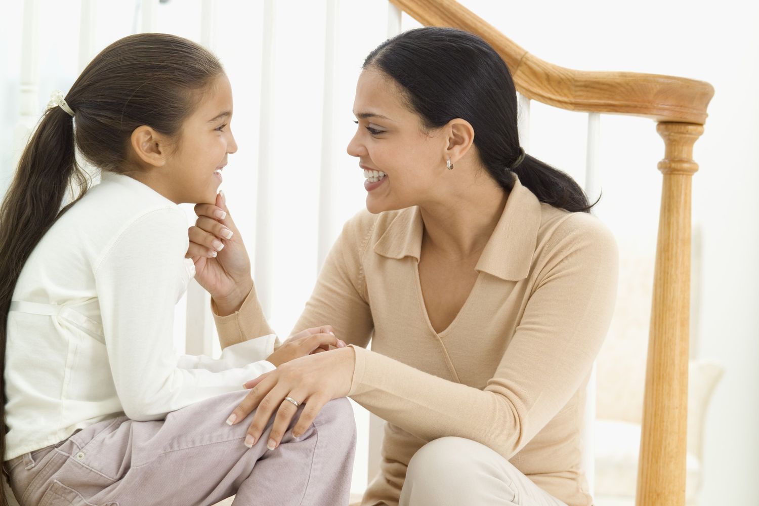 parent child communication - mother and daughter talking, smiling
