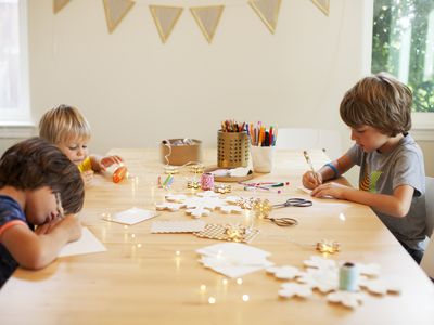Siblings making crafts at the table
