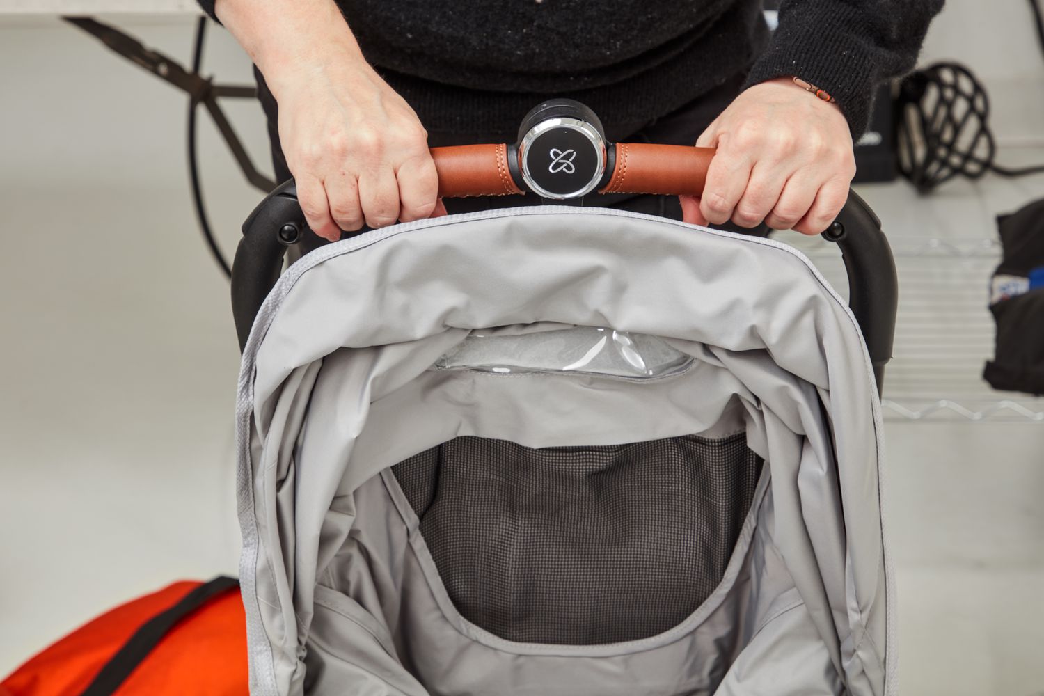 Close up of hand holding Silver Cross Jet 3 Super Compact Stroller