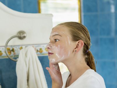 girl washing face with soap