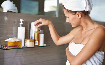 Woman picking lotion after shower