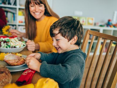 Happy kid eating at thanksgiving