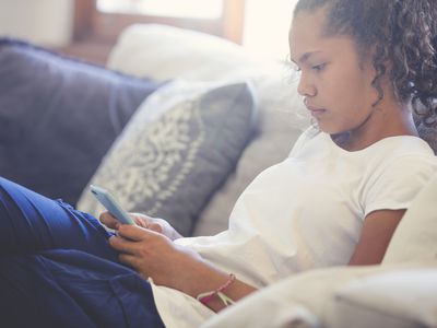 Upset teenager using her smartphone
