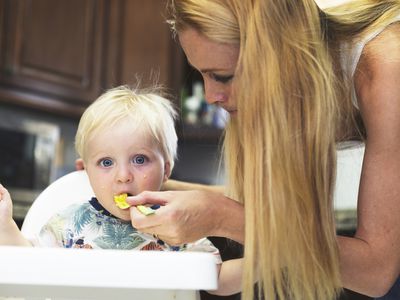 Mom feeding baby eggs