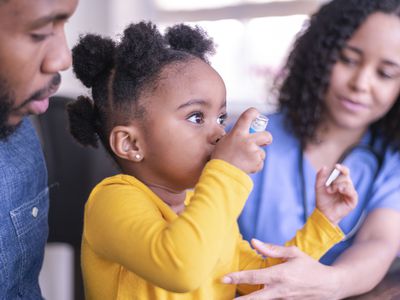 Little girl uses her inhaler