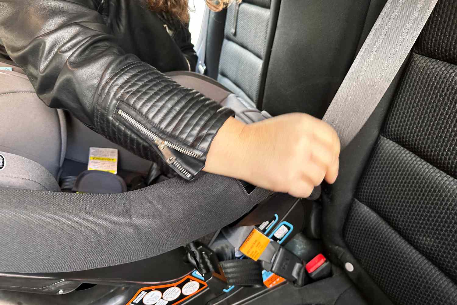 Person installing the Graco Contender Slim Convertible Car Seat