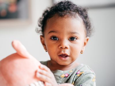 Baby girl holding a toy