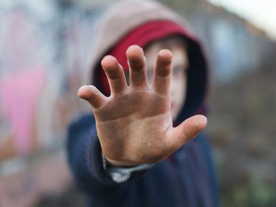 boy with his hand up 