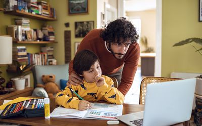Father helping his son with schoolwork