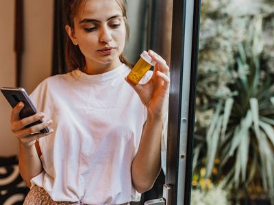 Woman looking at pills