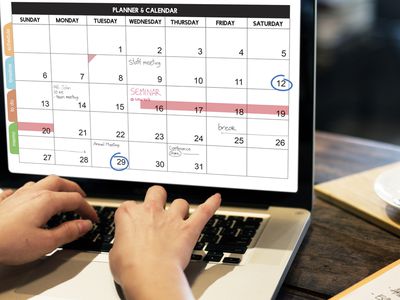 Woman looking at calendar on computer