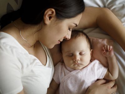 Sleeping baby with parent