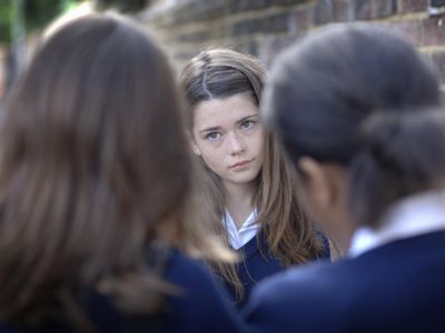 Two girls (12-13) bullying other school girl (10-11), differential focus