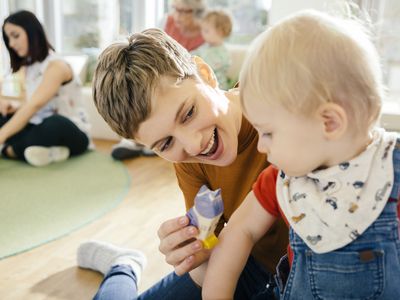 daycare provider playing with baby
