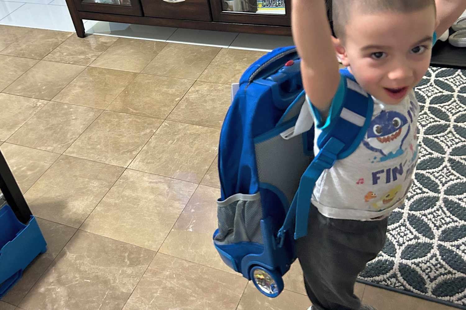 Kid wearing JWorld Sunrise Rolling Backpack