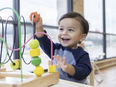 happy toddler playing with a toy