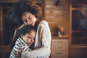 Black mother embraces child