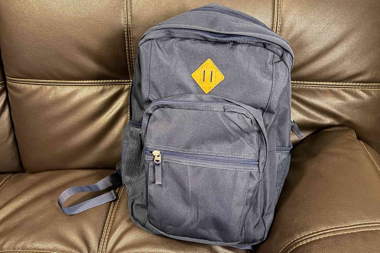 Abshoo Classical Basic Travel Backpack For School displayed on couch