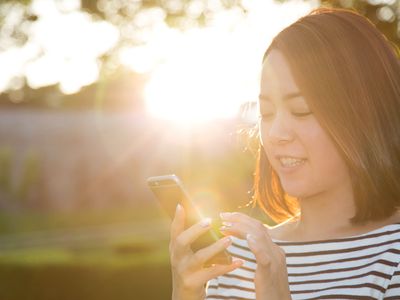 Woman using an ovulation calculator/calendar app on her smart phone