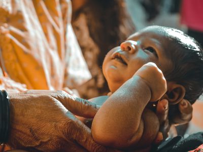 Grandparent holding newborn baby