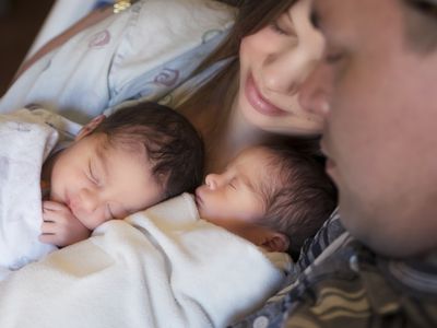 Couples looks on at their twin babies