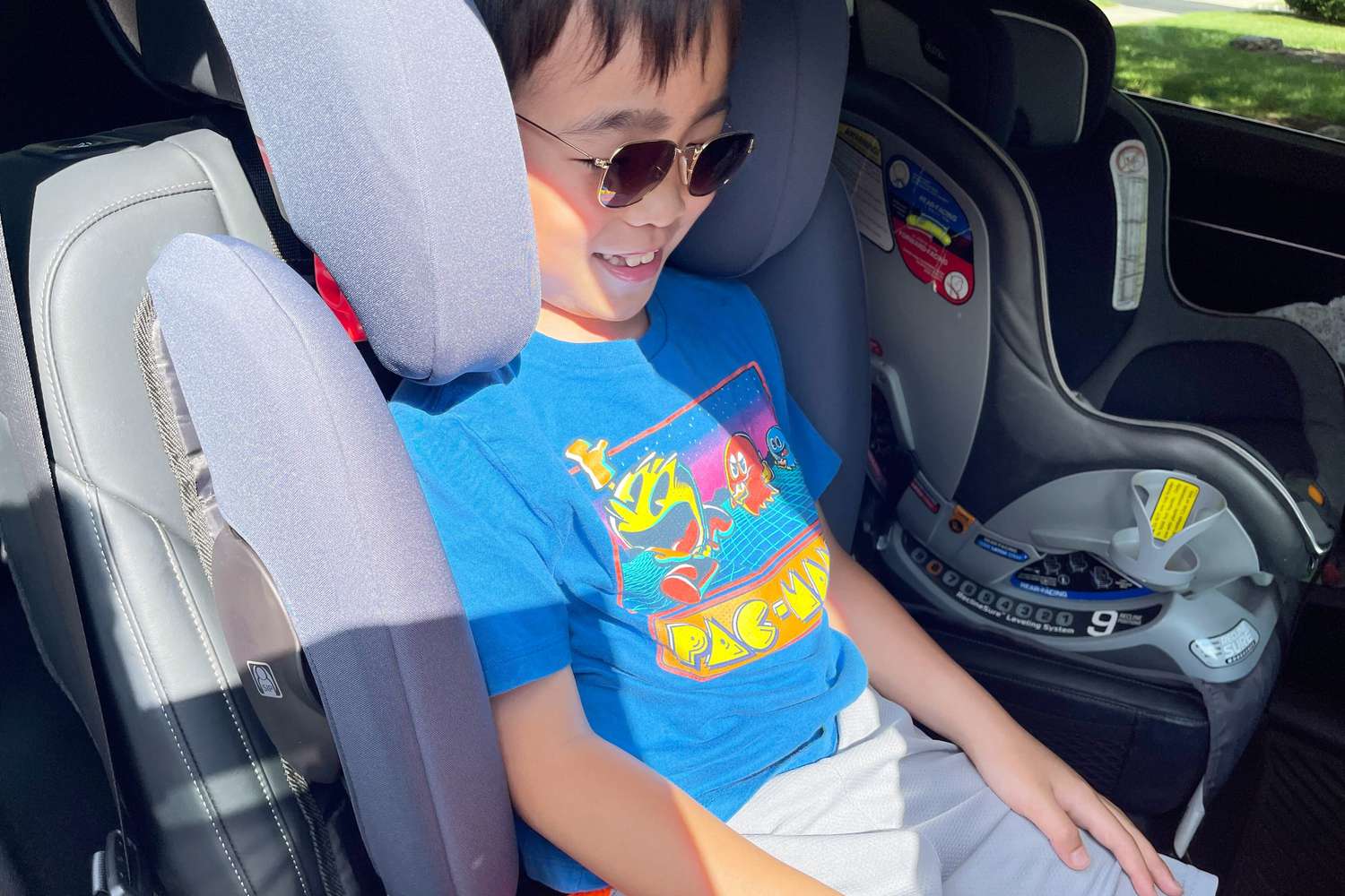 A child sits in Nuna AACE Booster Seat inside a vehicle.