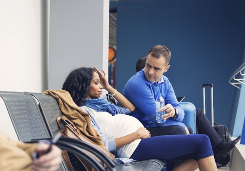 Pregnant woman getting ready to fly