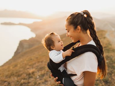 Baby in baby carrier with mother