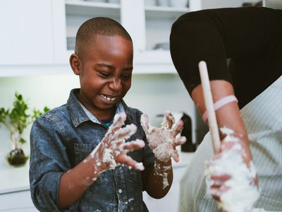 Happy boy with sticky dough hands
