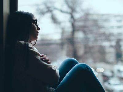 upset girl in window