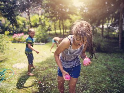 Children having water balloon fight