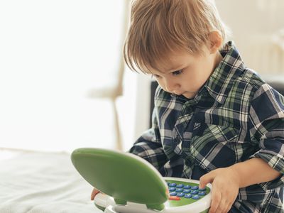 Boy using toy laptop