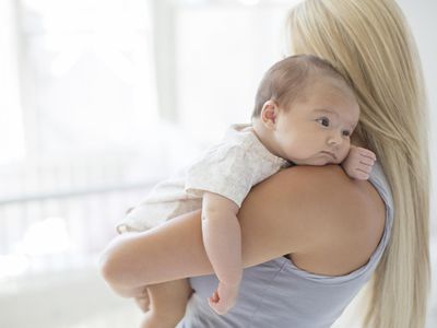 Mother holding baby girl in nursery