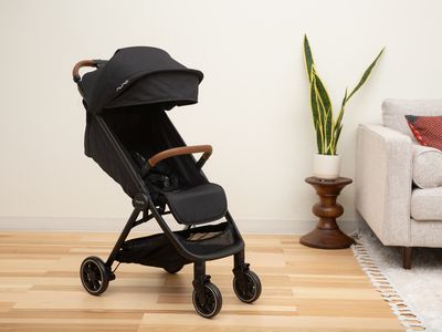 Nuna TRVL travel stroller displayed on a wooden floor in a living room