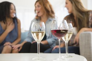Wine glasses with women in the background