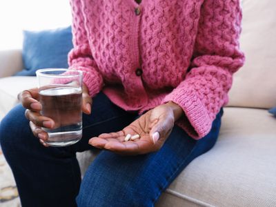 person holding pills