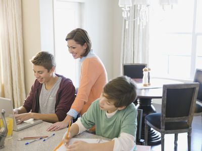 Mother assisting son with homework