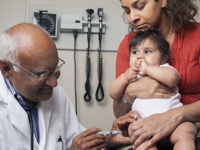 Baby getting vaccinated by Doctor