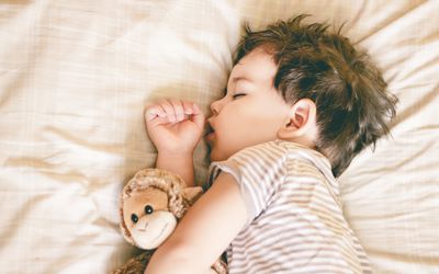 Toddler asleep in bed