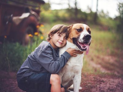 Boy hugging dog