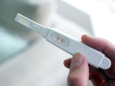 Woman holding a pregnancy test device